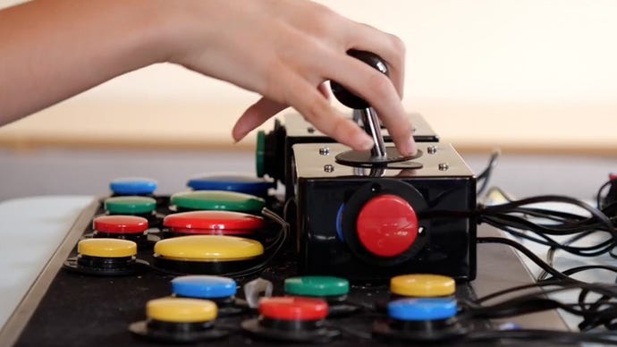 A set of assistive buttons and joysticks being used by a gamer.