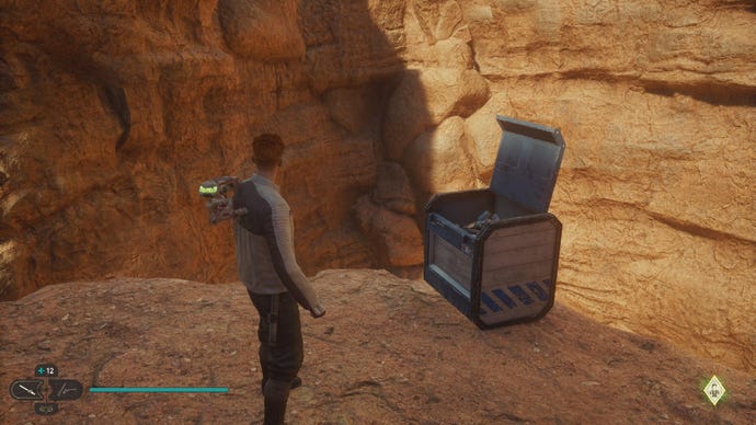 Star Wars Jedi Survivor image showing Cal stood by an open chest on a high ledge in the desert.