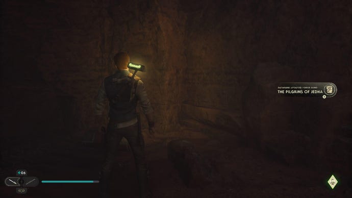 Star Wars Jedi Survivor screenshot showing Cal staring at a scan point in a dark cave.