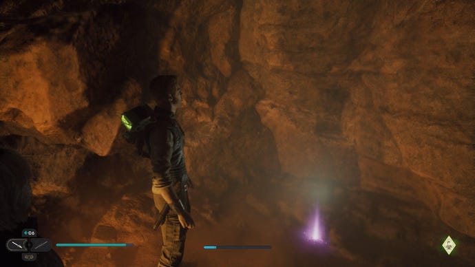 Star Wars Jedi Survivor screenshot showing Cal stood by a Force Essence in a dark cave.