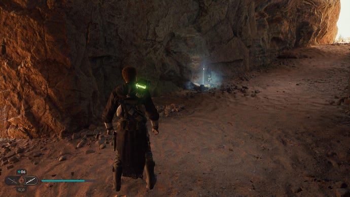 Star Wars Jedi: Survivor screenshot showing Cal stood in a desert cave, near a glowing blue Force Echo.