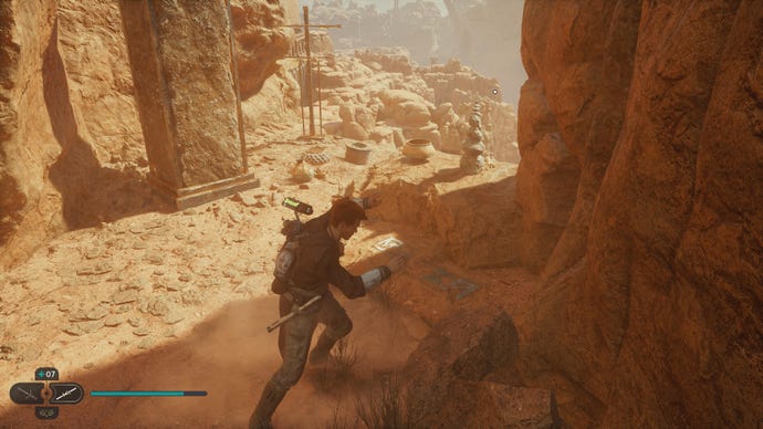 Star Wars Jedi: Survivor screenshot showing Cal stood near some rocks in the desert.