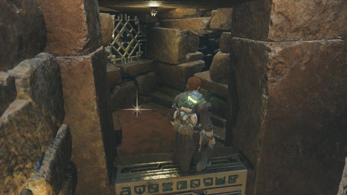 Star Wars Jedi Survivor screenshot showing Cal stood by a Jedha Scroll glint in a ruin on Jedha.