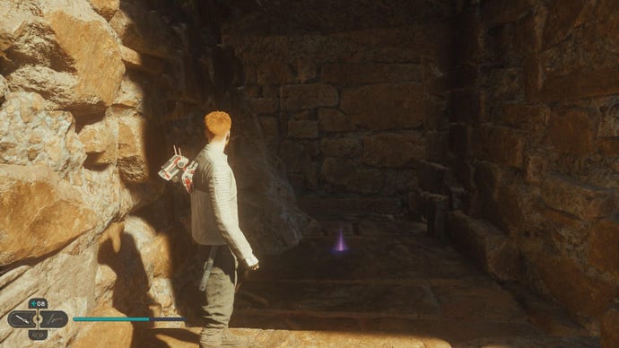 Star Wars Jedi Survivor screenshot showing Cal stood on a dark sandy ledge, near a purple Essence on the floor.