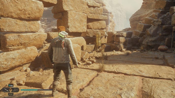 Star Wars Jedi Survivor screenshot showing Cal stood near a Jedha Scroll on a sandy ledge.