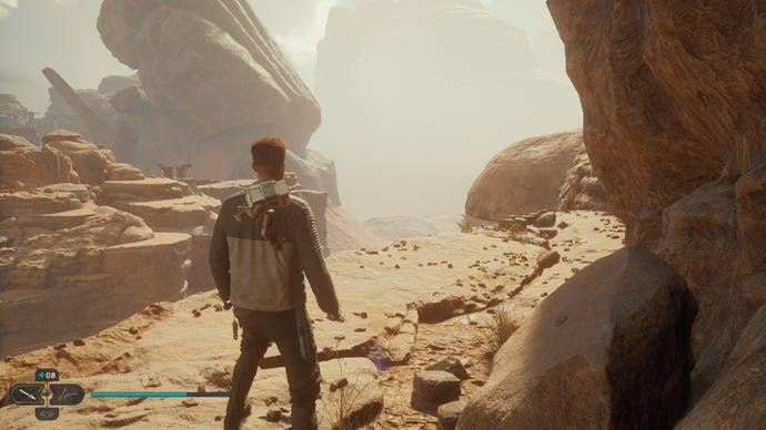 Star Wars Jedi Survivor screenshot showing Cal stood on a ledge overlooking the desert.
