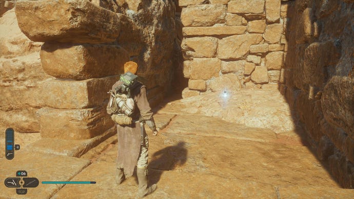 Star Wars Jedi Survivor screenshot showing Cal staring at a Force Essence glow in the sandy ruins of Jedha.