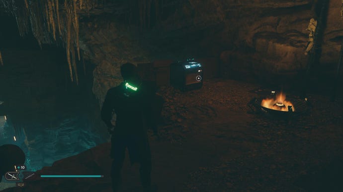 Star Wars Jedi Survivor screenshot showing Cal stood near a chest in a dark cave.