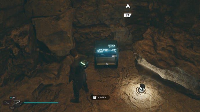 Star Wars Jedi Survivor screenshot showing Cal stood near a chest in a cave.