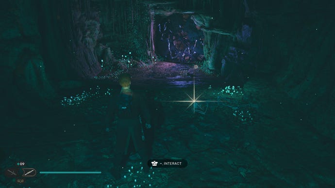 Star Wars Jedi Survivor screenshot showing Cal stood near a glistening Datadisc in a dark cave.