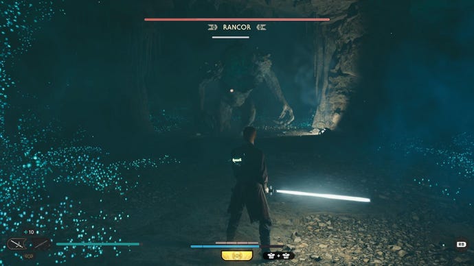 Star Wars Jedi Survivor screenshot showing Cal wielding a lightsaber as he faces a Rancor.