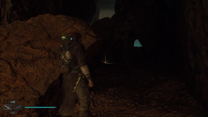 Star Wars Jedi: Survivor screenshot showing Cal stood in a dark cave.