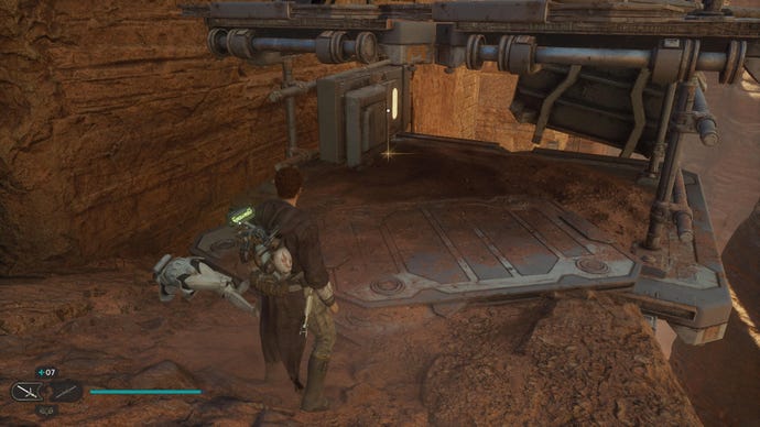 Star Wars Jedi: Survivor screenshot showing Cal stood on a rocky ledge in the desert.
