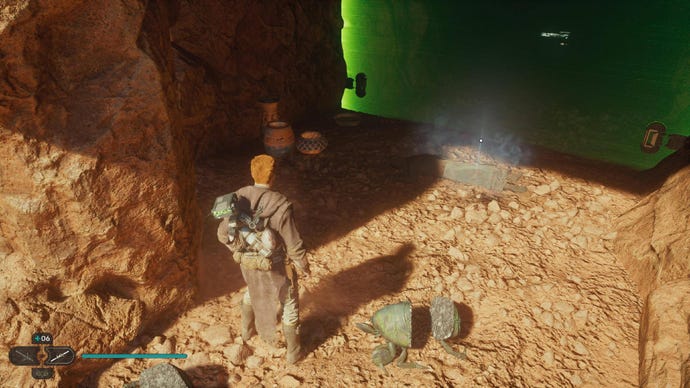 Star Wars Jedi: Survivor screenshot showing Cal stood by a green laser door on a rocky, sand-covered ledge.