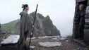 Star Wars The Last Jedi Daisy Ridley as Rey, looking at Mark Hamill as Luke Skywalker as he stands in the entrance of a stone doorway