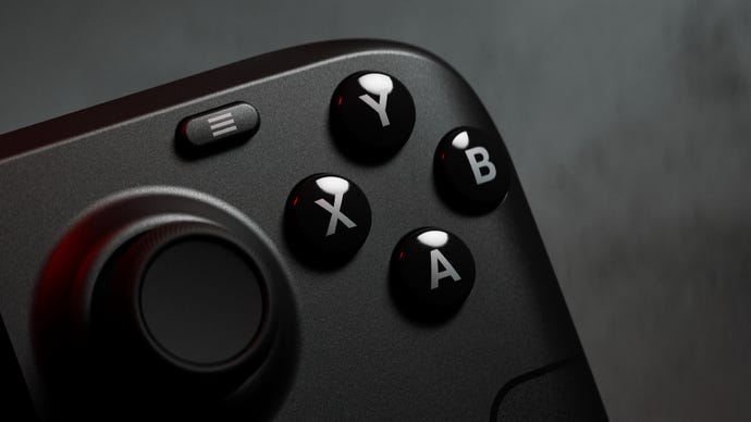 A close-up of the Steam Deck OLED, seeing the four face buttons glinting in some lovely red-ish light.