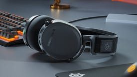 The SteelSeries Arctis 7 gaming headset on a desk, next to some other SteelSeries peripherals.