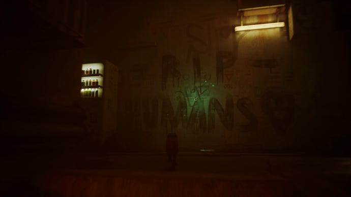 Stray screenshot showing a Vending machine lit up next to some graffiti that reads "RIP Humans" in a very dark alleyway.