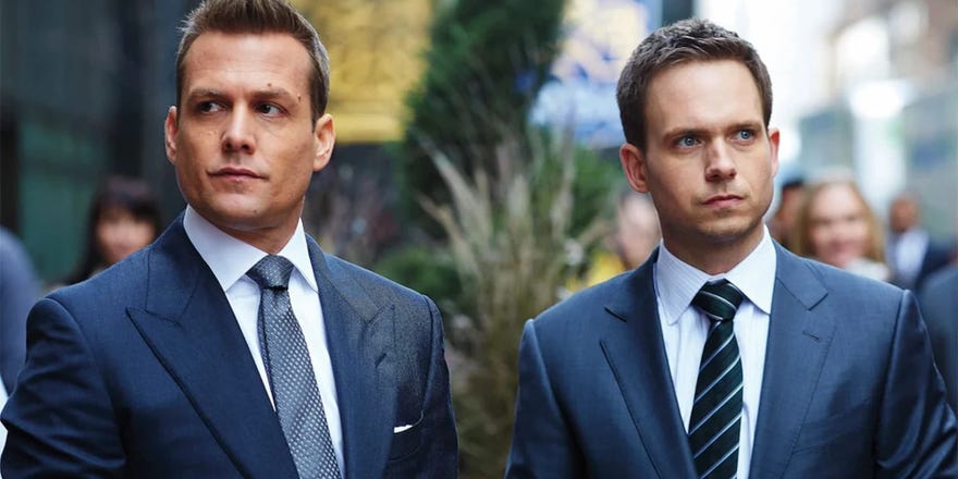 Two main characters of Suits wearing suits