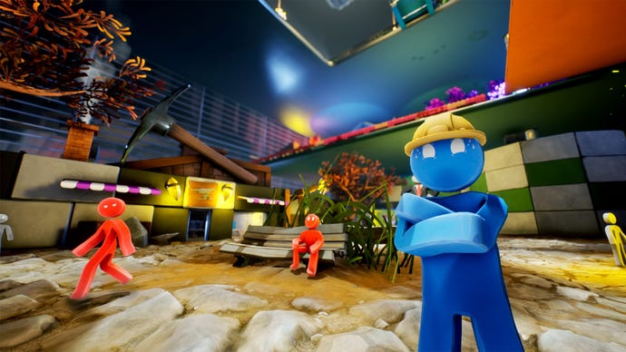 A blue man with a yellow hardhat stands in front of a cartoony work site in Supraland Six Inches Under