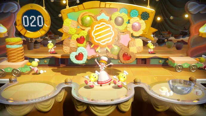 Princess Peach: uno screenshot di Showtime che mostra un mini gioco di pasticceria, con cupcakes su un nastro trasportatore.
