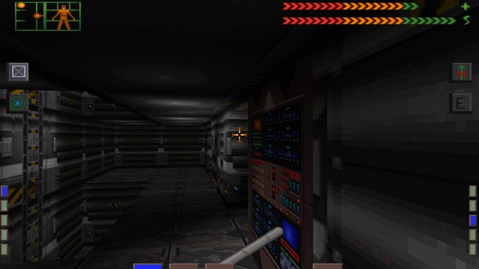 The player walks down a dark corridor in System Shock