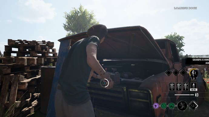 The Hitchhiker looks into the engine of a dilapidated truck. A quick-time button tells the player to hold X to switch on the power and electrify the exit gate