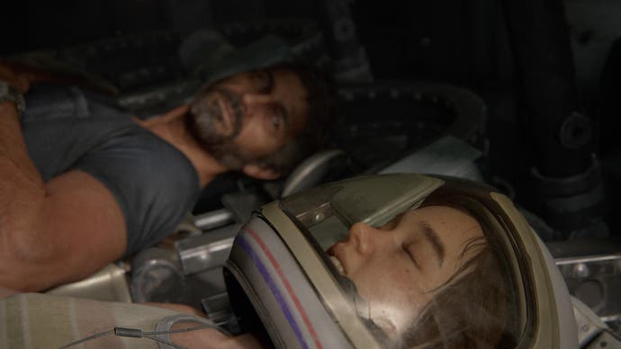 Joel lays in the background and stares fondly towards the foreground, where Ellie is lying, eyes closed in an astronaut helmet.