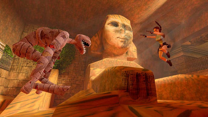 Lara Croft leaps in the air while aiming two pistols, facing a mummified dog (or other animal, it's hard to tell). In the background is a Sphinx with a partially shattered face.