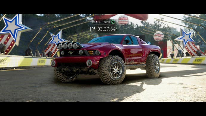 The Crew Motorfest screenshot, showing a closeup of a Ford Mustang monster-truck hybrid beast, splattered with mud.
