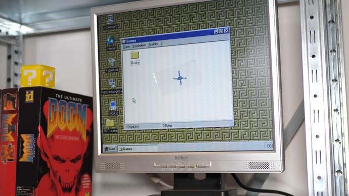 a photo of a tape crudely applied to the centre of a PC monitor, with a crosshair daubed on it