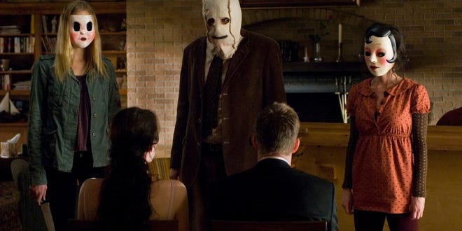 Characters in creepy masks from The Strangers