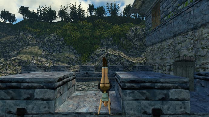 Lara does a hand stand on the Great Wall in this screen from Tomb Raider Remastered