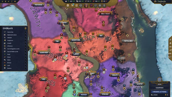 The campaign map shows red, orange and purple territories in Total War: Pharaoh as factions compete for control of the Nile.