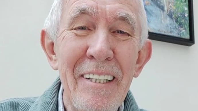 The smiling face of Richard Wells, voice of the PEGI logos. He has cropped white hair and stubble, and wears a denim jacket.
