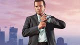GTA 5 main character Michael De Santa in a suit stands in front of the Los Santos skyline, loading a pistol.