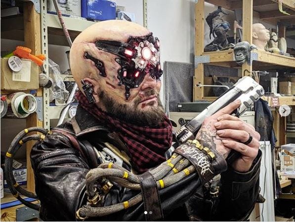 Cosplayer Vulture Productions in his Cyberpunk 2077 cosplay for their cosplay contest.