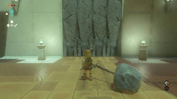 Link faces a stone door while holding a Boulder Hammer in the In-Isa Shrine of The Legend of Zelda: Tears of the Kingdom
