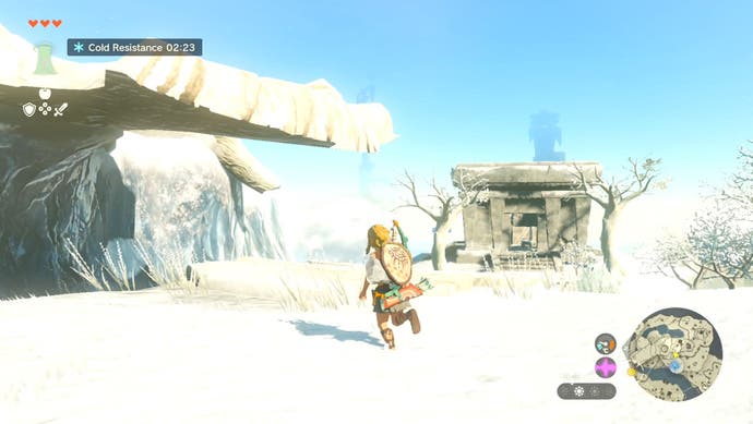 Link exploring a snowy region with a stone building in the background in The Legend of Zelda: Tears of the Kingdom.