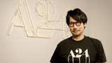 Death Stranding creator Hideo Kojima stands in front of an A24 sign, wearing an A24 top