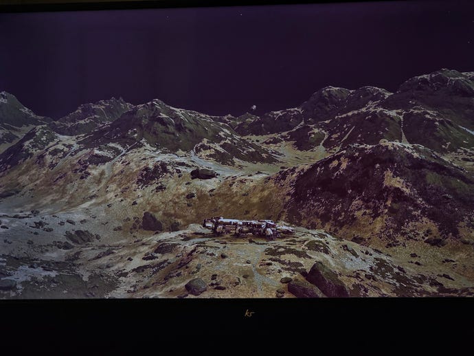 A screenshot of a glitchy ghost asteroid above a planet's surface in Starfield, posted by Twitter user Niall H.