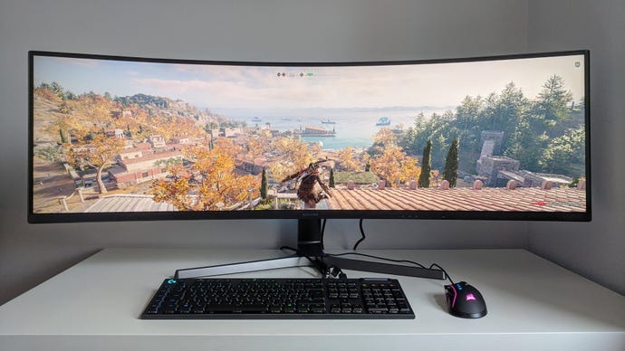 A photo of an ultrawide gaming monitor running Assassin's Creed Odyssey