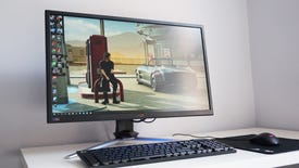 A photo of the Acer Nitro XV273K on a desk behind a mouse and keyboard