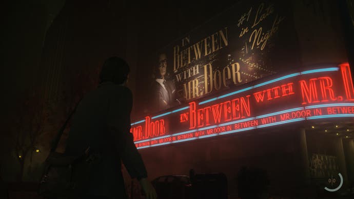 A screenshot from Alan Wake 2 showing Alan outside a large recording studio/theatre marquee for the late night talkshow In Between with Mr. Door