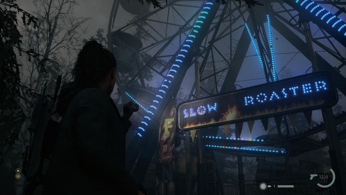 A screenshot from Alan Wake 2 showing Saga is observing a coffee-themed ferris wheel called The Slow Roaster