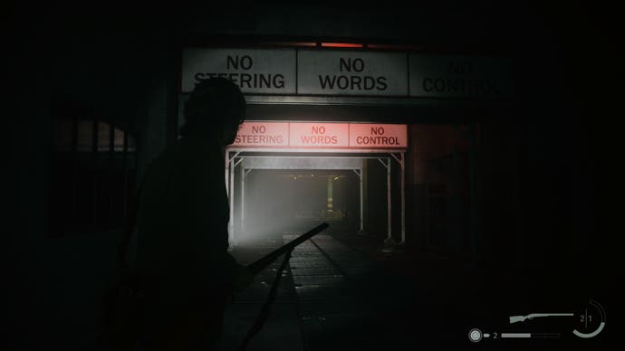 A screenshot from Alan Wake 2 showing a drive-through car wash with the sign “NO STEERING / NO WORDS / NO CONTROL”