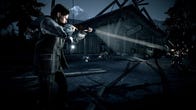 Alan Wake fires a gun into the darkness in Alan Wake