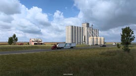 A grain silo in a flat grass landscape in the Kansas DLC for American Truck Simulator.