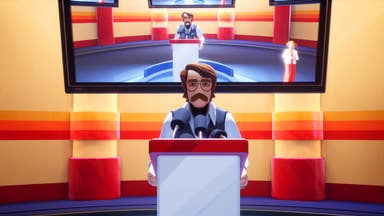 A screenshot from American Arcadia. Think 1970s. A man - Trevor - stands behind a podium ready to address an audience, with a TV screen hanging behind him. The room around him is all oranges and reds, and he has a moustache and glasses and longish frumpy hair. And a tank top. Don't forget the tank top.