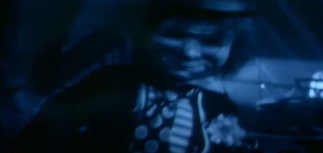 A scary image of a doll, from opening credits